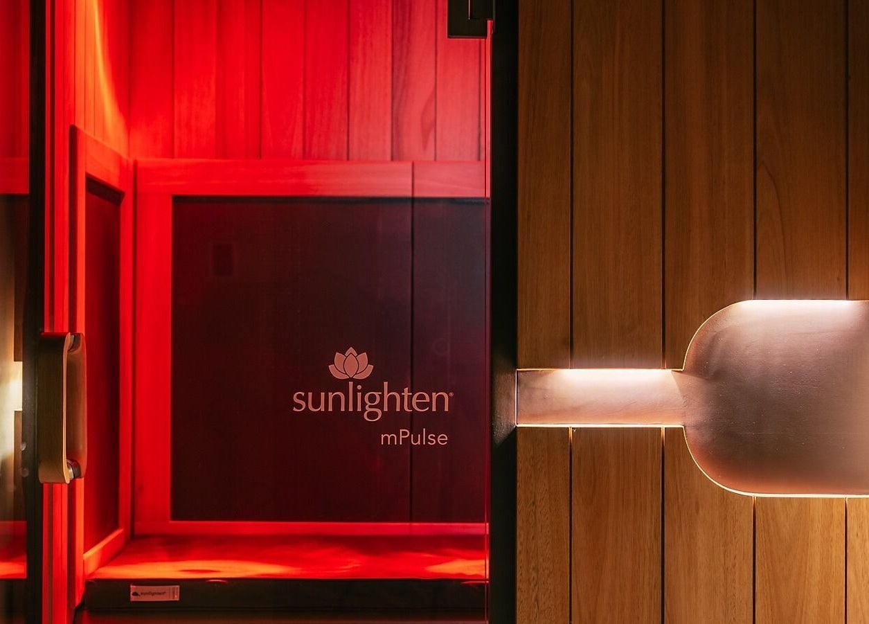 Luxurious infrared sauna at Wellnest, Dubai, AE, featuring warm wood panels and ambient lighting.