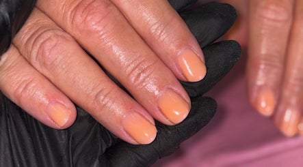 Fresh peach nail polish on hands by Mobile nails by Karli in Stilton, England, GB.