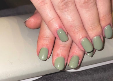Green manicure by Mobile Nails by Karli in Stilton, England. Elegant, freshly painted nails on a hand rest.