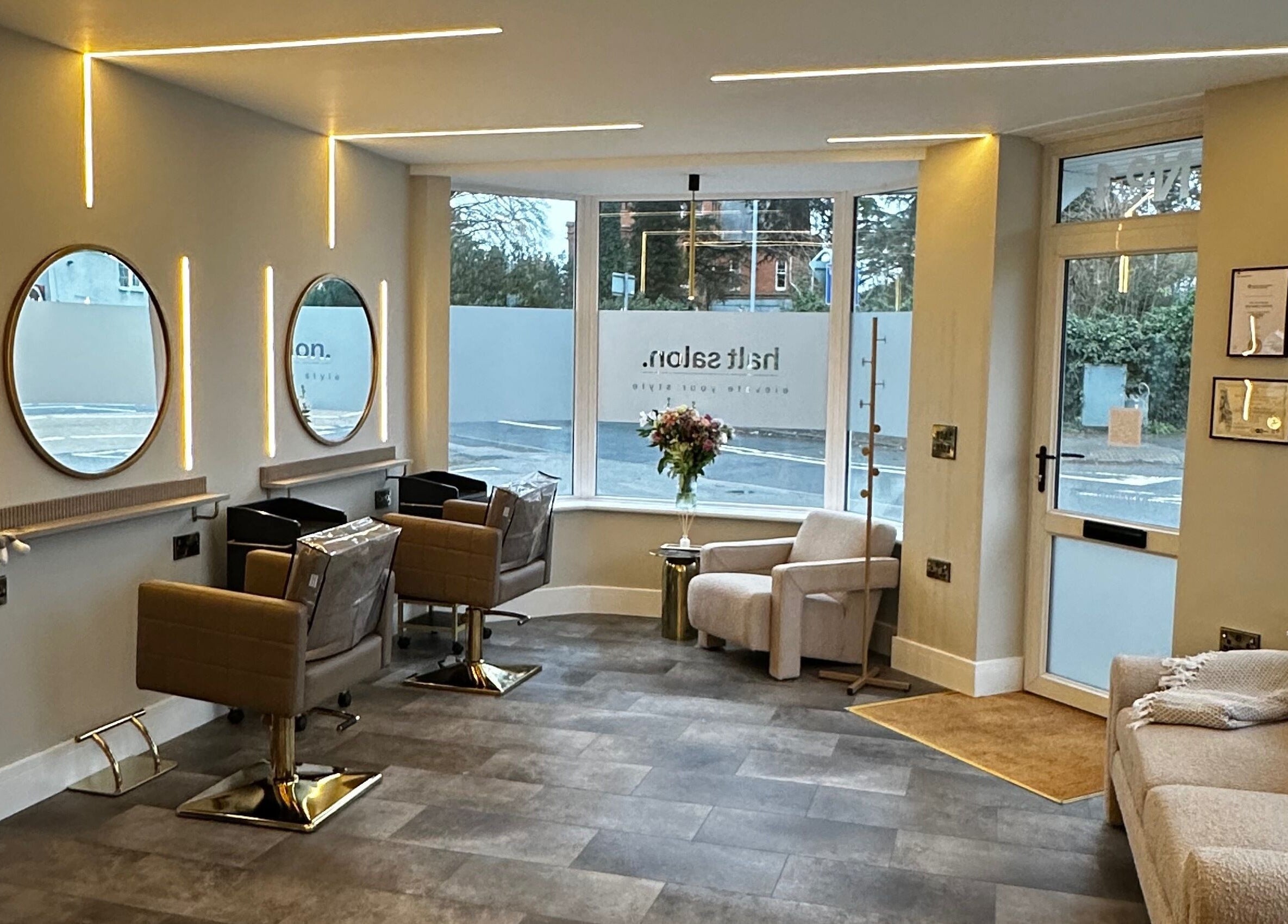 Elegant interior of Halt Salon, Nottingham, GB with modern chairs and mirrors, exuding luxury and style.