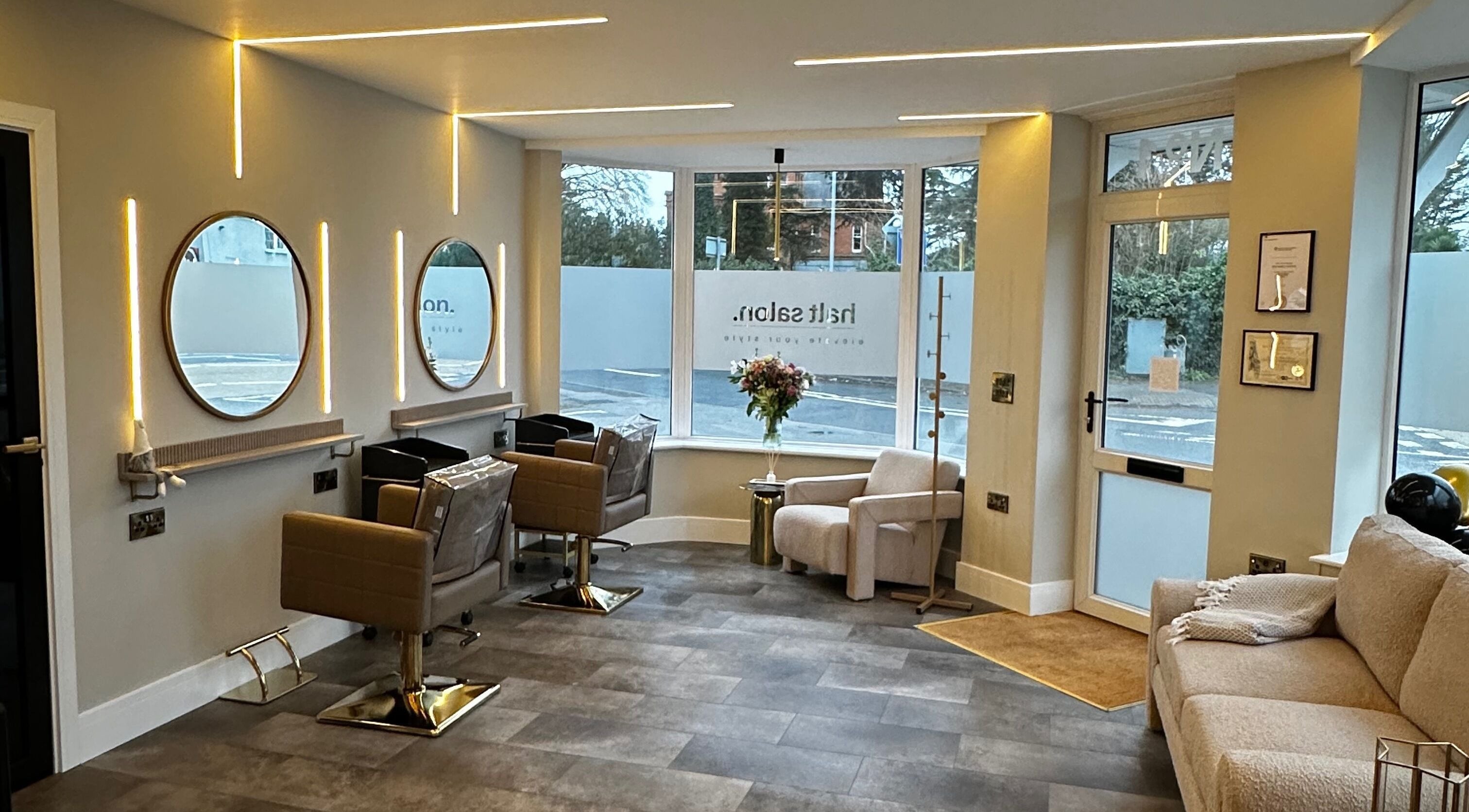 Elegant interior of Halt Salon, Nottingham, GB with modern chairs and mirrors, exuding luxury and style.