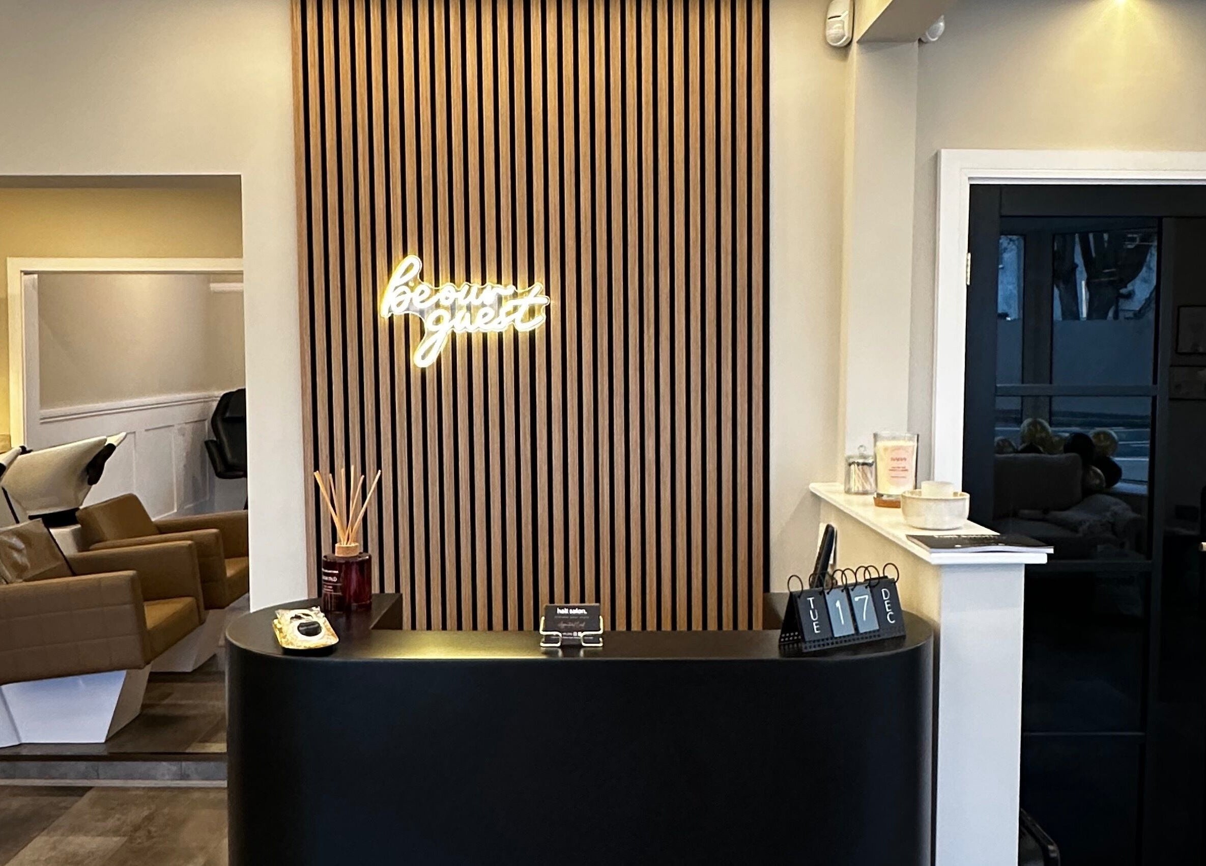 Reception area at Halt Salon, Nottingham, GB with sleek decor and modern seating.