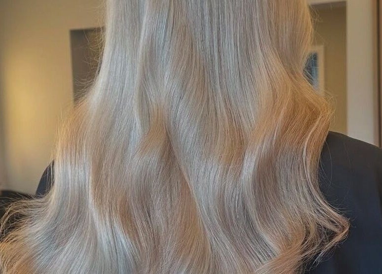 Blonde wavy hairstyle at Halt Salon, Nottingham, GB, showcasing silky, smooth hair in elegant waves.