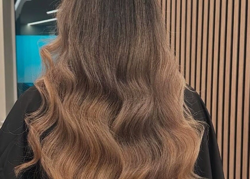 Elegant wavy hairstyle showcased at Halt Salon, Nottingham, GB with a stylish modern interior.