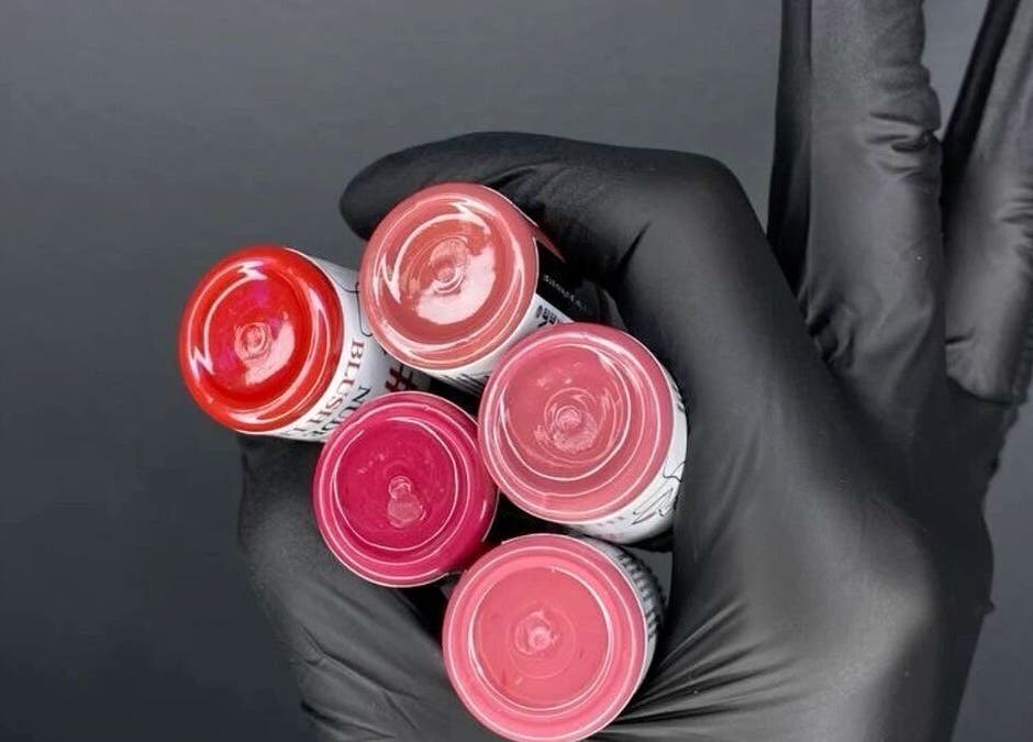 A gloved hand holding colorful pigments at Pigment Perspective, Lihue, Hawaii, US.