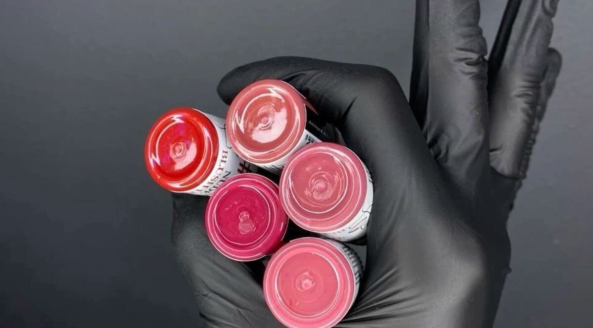 A gloved hand holding colorful pigments at Pigment Perspective, Lihue, Hawaii, US.