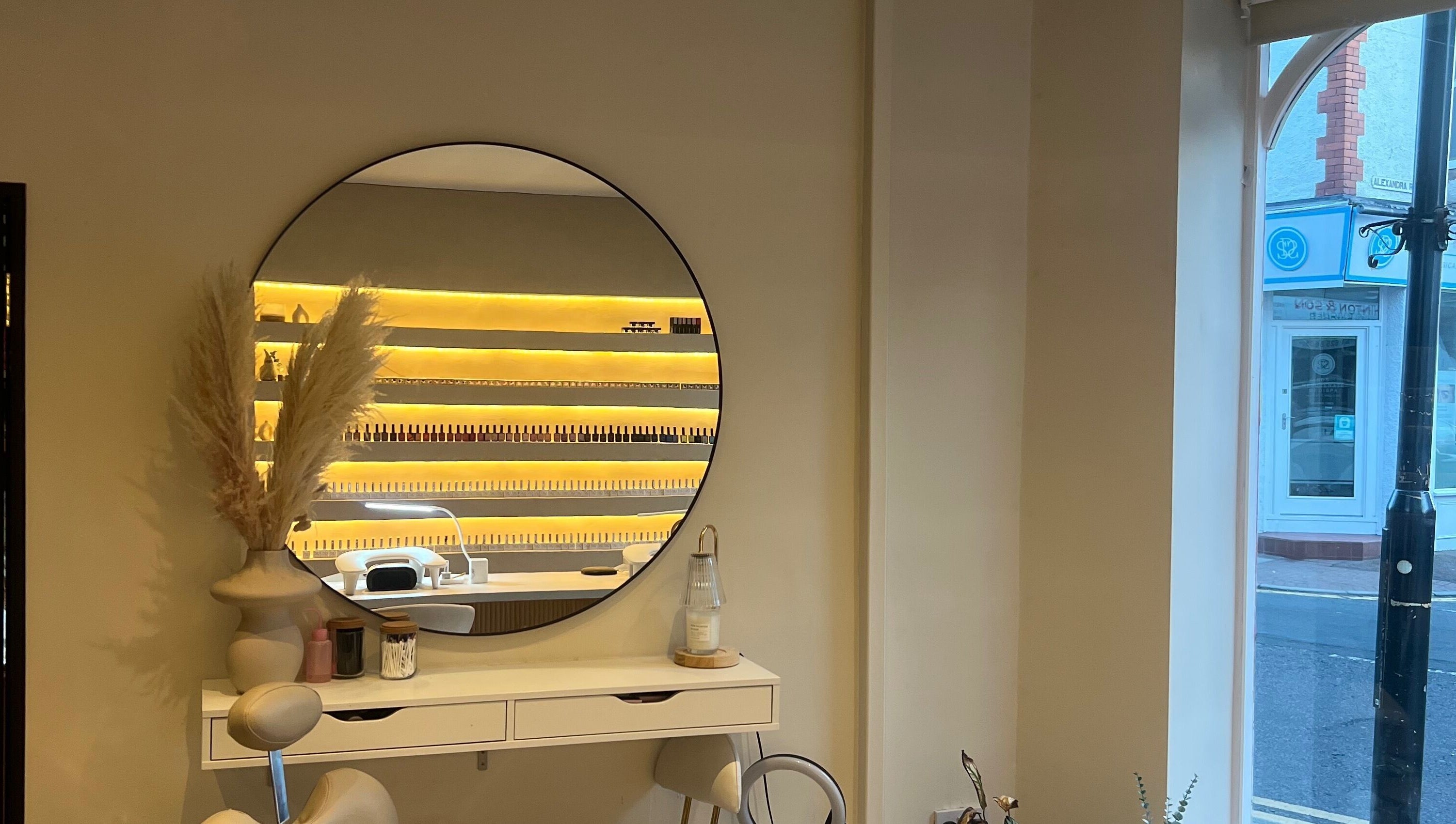 Chic salon interior with a mirror at Byinke_X, West Kirby, England, GB, showcasing elegant decor and manicure setup.