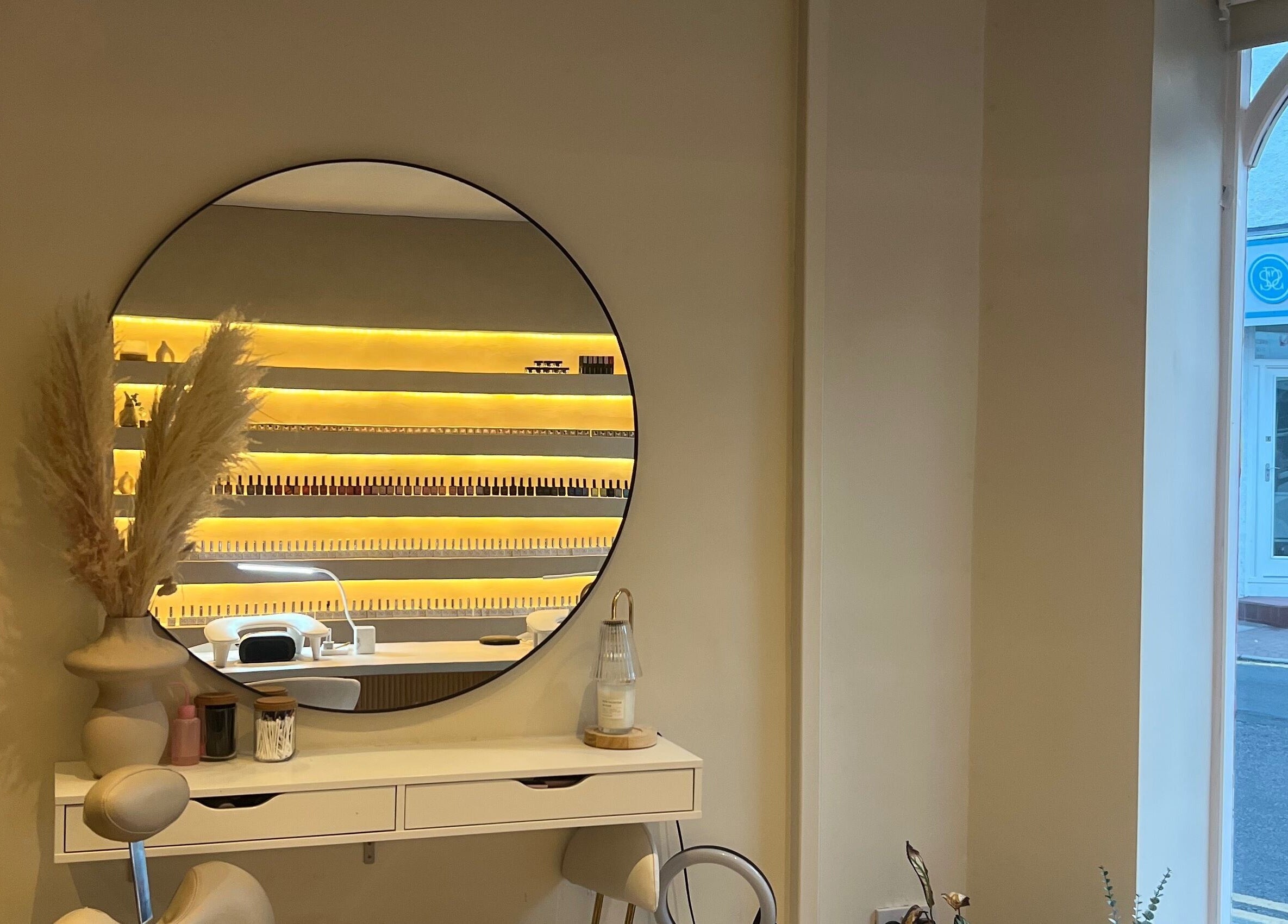 Chic salon interior with a mirror at Byinke_X, West Kirby, England, GB, showcasing elegant decor and manicure setup.