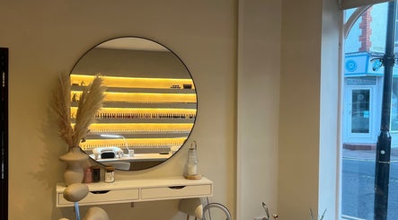 Chic salon interior with a mirror at Byinke_X, West Kirby, England, GB, showcasing elegant decor and manicure setup.
