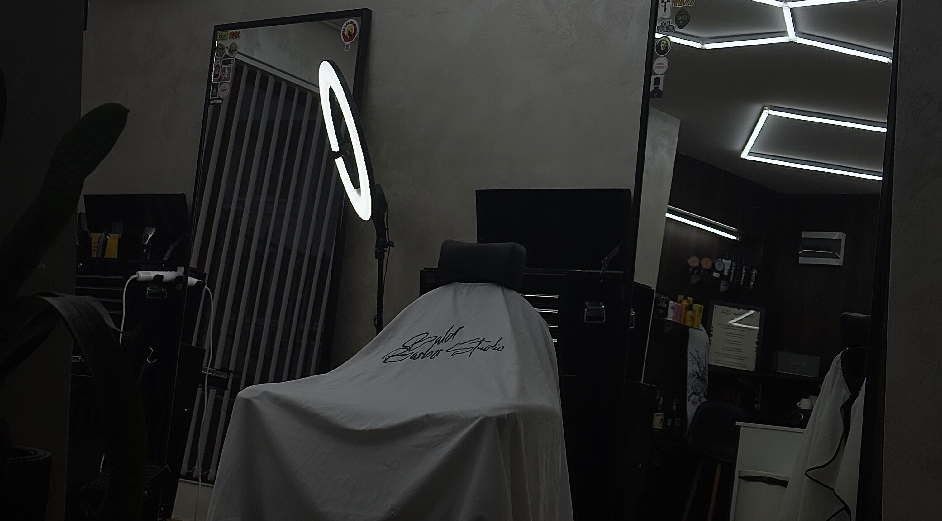 Modern barbershop interior at Bald Barber Studio, Varna, Varna, BG featuring sleek mirrors and styling tools.