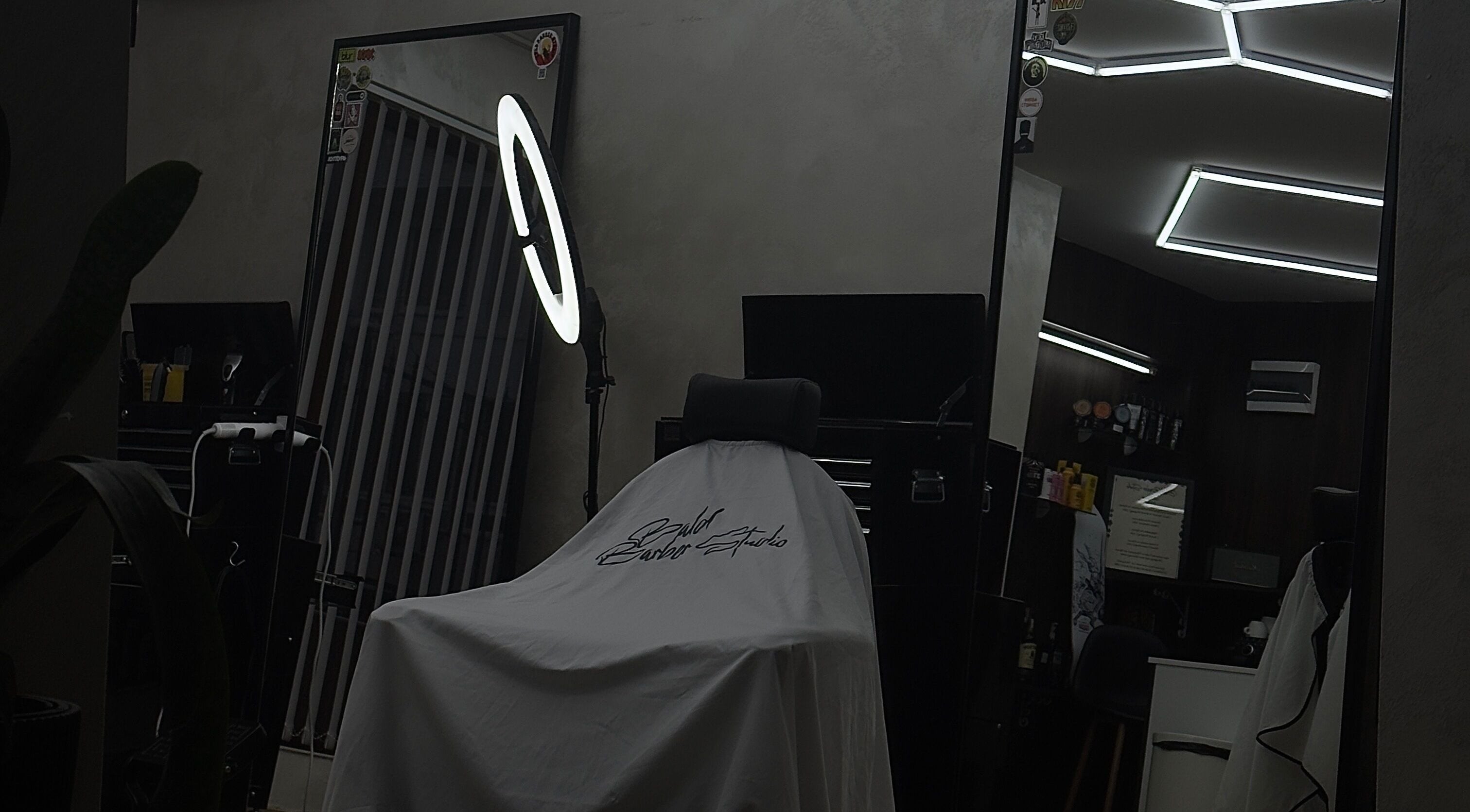 Modern barbershop interior at Bald Barber Studio, Varna, Varna, BG featuring sleek mirrors and styling tools.