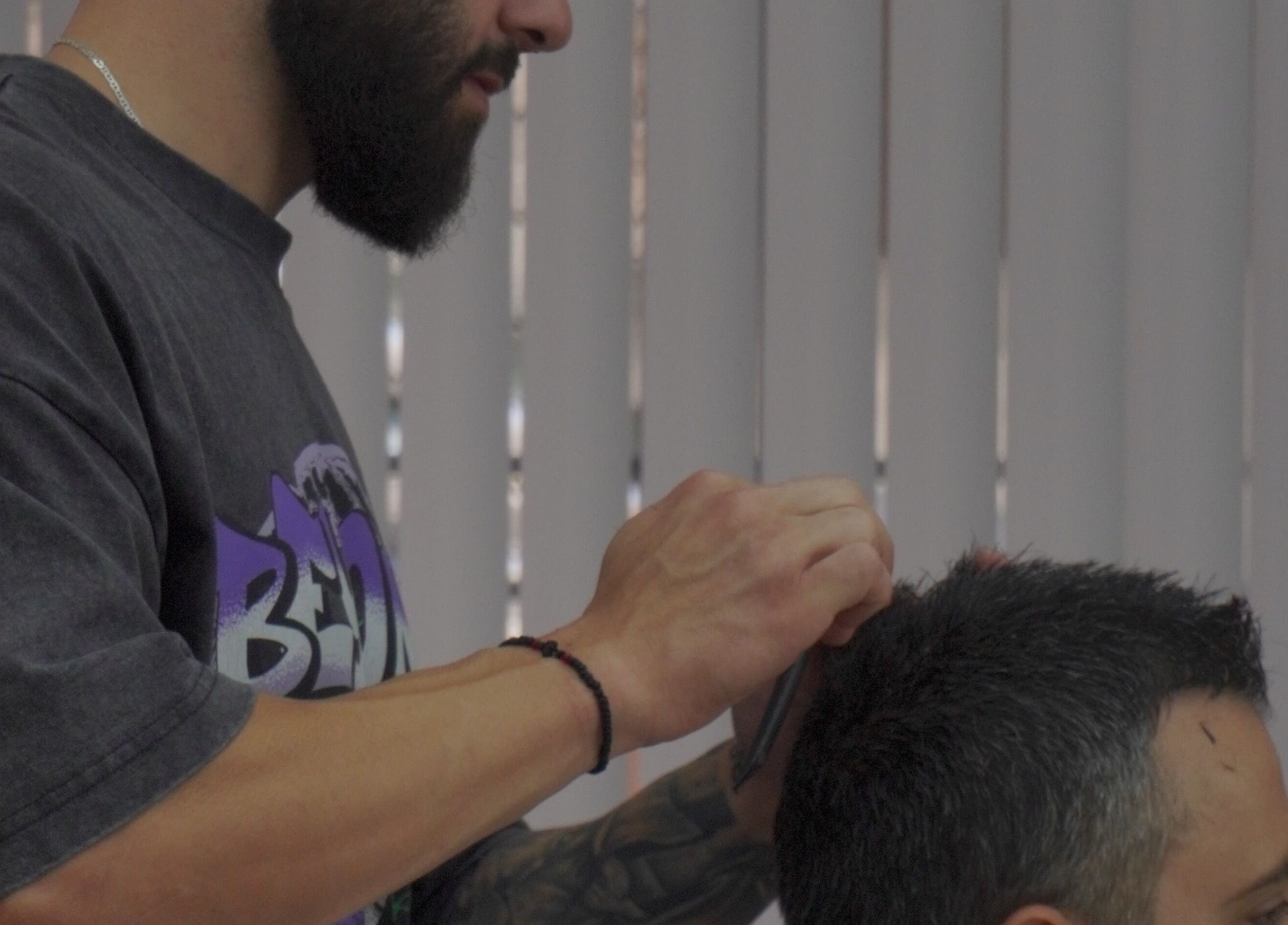 Barber styling client's hair at Bald Barber Studio, Varna, Varna, BG. Professional grooming in action.