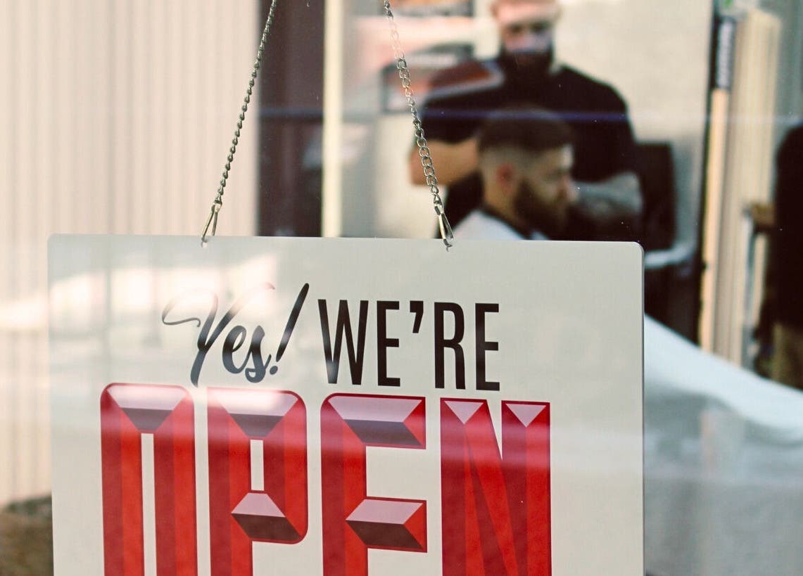 Open sign at Bald Barber Studio, Varna, Varna, BG. Inviting atmosphere visible through the window.