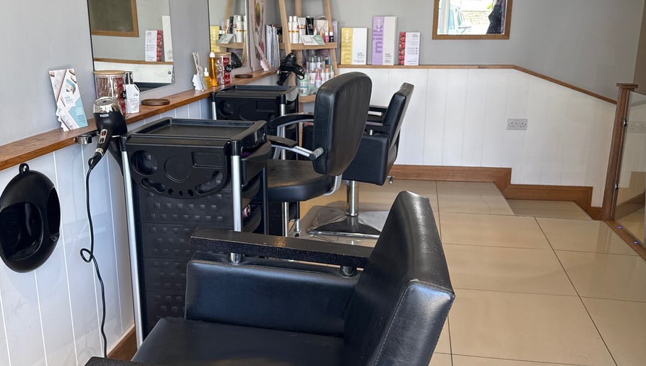 Modern styling station at Lavender Salon, Bradworthy, England, GB, featuring sleek black chairs and professional equipment.