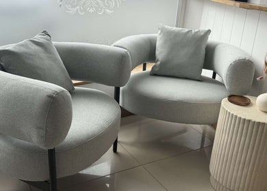 Elegant seating area in Lavender Salon, Bradworthy, England, GB with stylish chairs and side table.