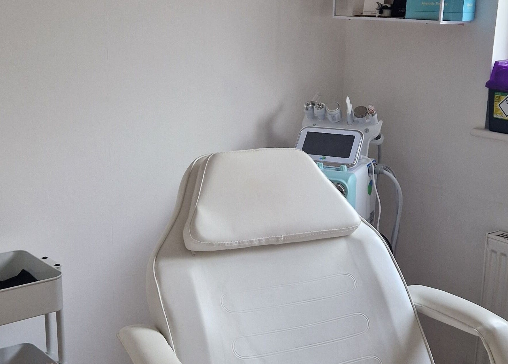 Relaxing treatment room at Revive Esthetics, Peacehaven, England, GB, featuring a comfortable chair and modern equipment.