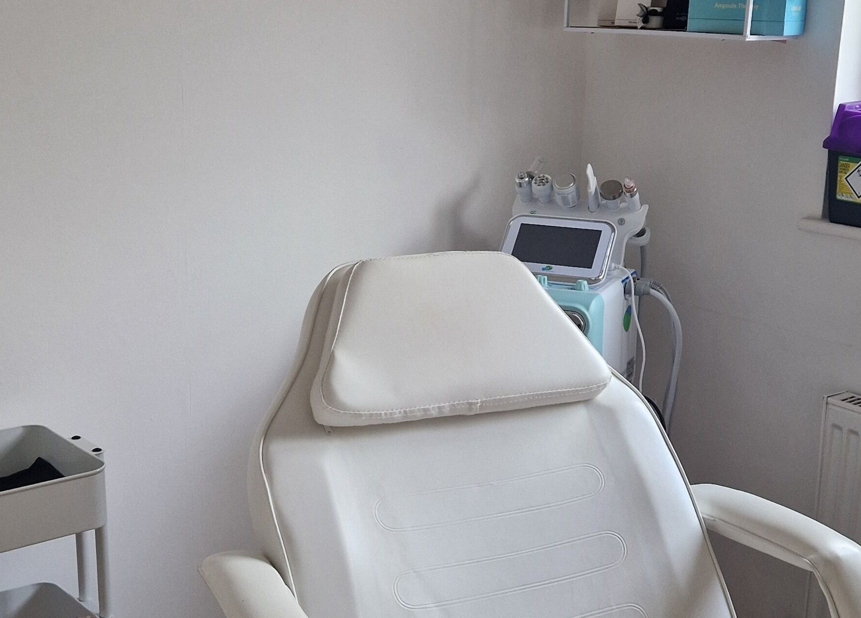 Relaxing treatment room at Revive Esthetics, Peacehaven, England, GB, featuring a comfortable chair and modern equipment.