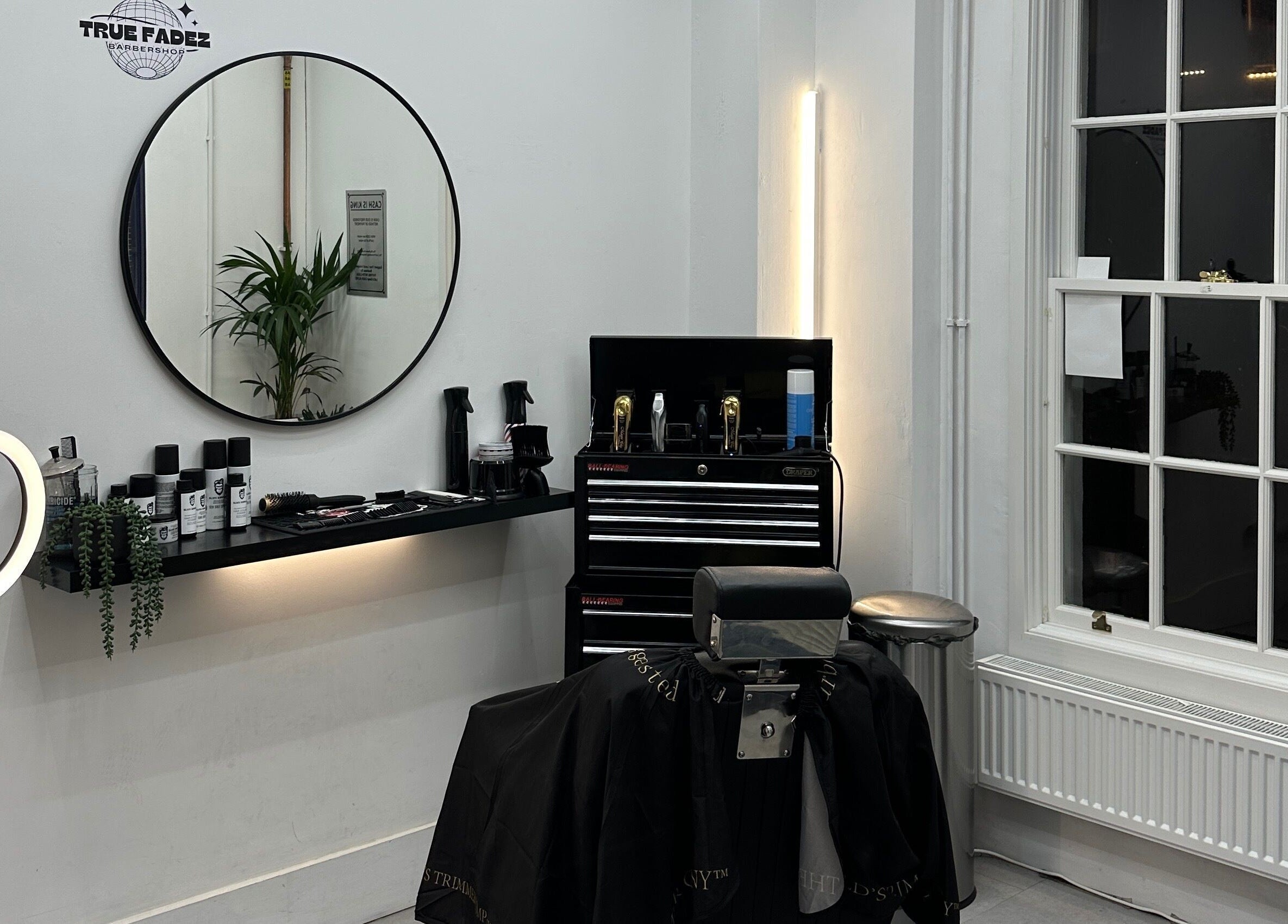 Modern barber station at True Fadez, Castletown, featuring tools and a stylish mirror.