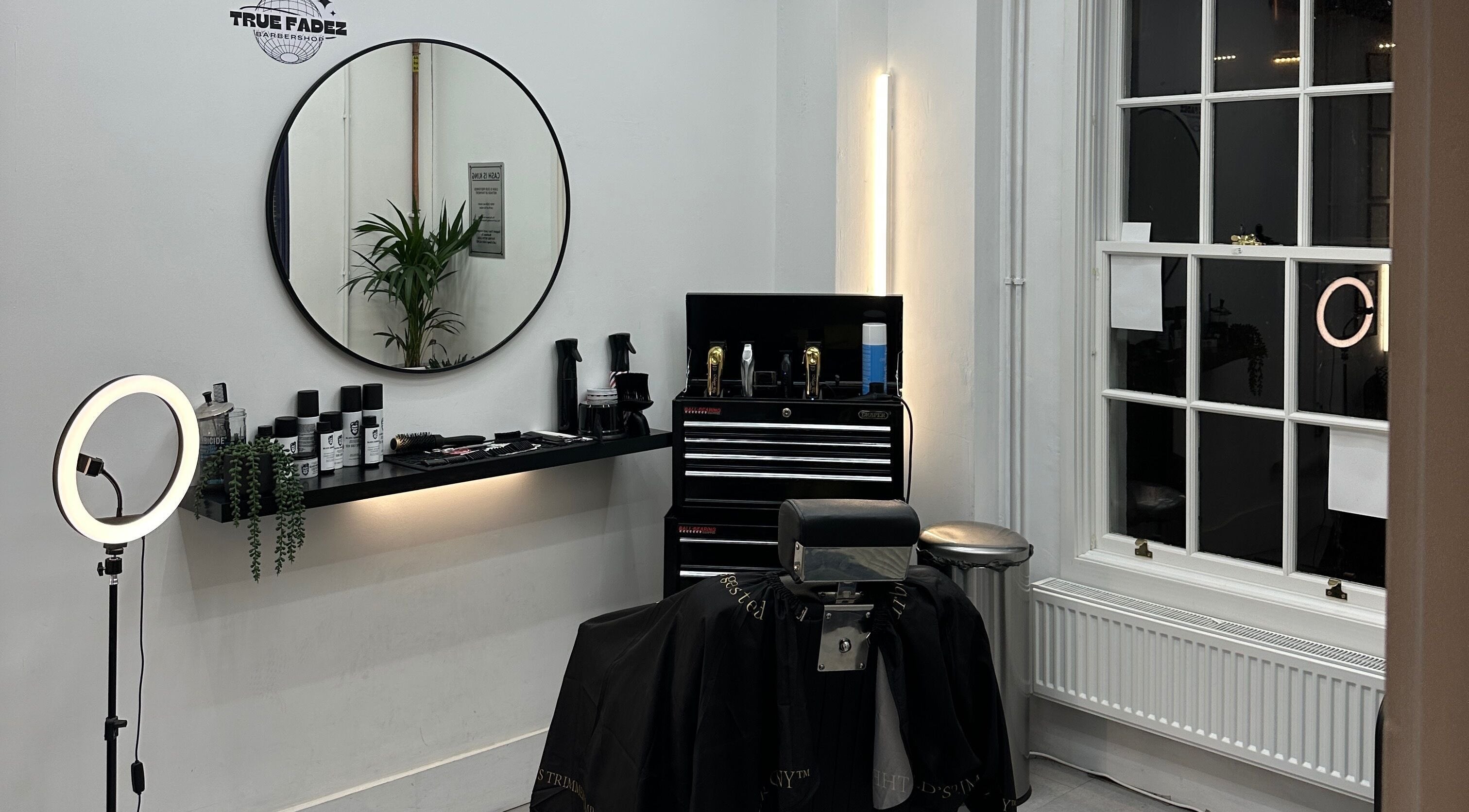 Modern barber station at True Fadez, Castletown, featuring tools and a stylish mirror.