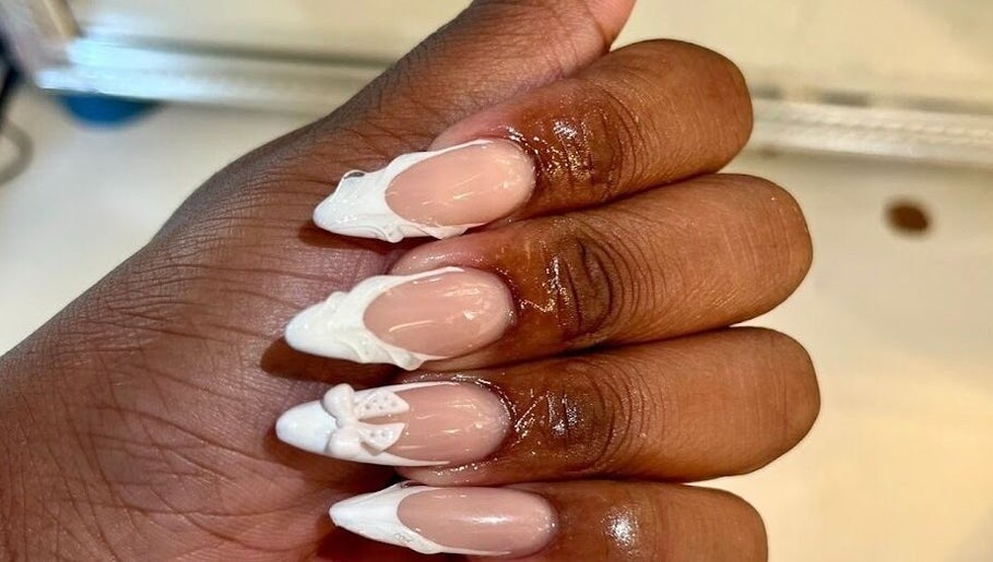 Intricate white nail art on manicured hand at Khanyela Luxe Studio, Randburg, Gauteng, ZA.