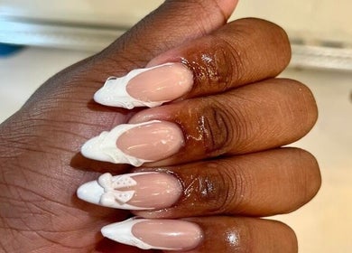 Intricate white nail art on manicured hand at Khanyela Luxe Studio, Randburg, Gauteng, ZA.