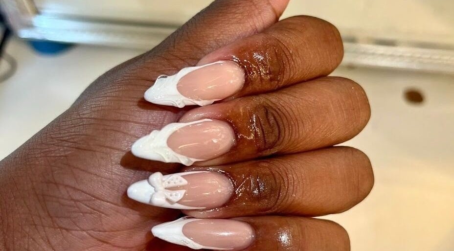 Intricate white nail art on manicured hand at Khanyela Luxe Studio, Randburg, Gauteng, ZA.