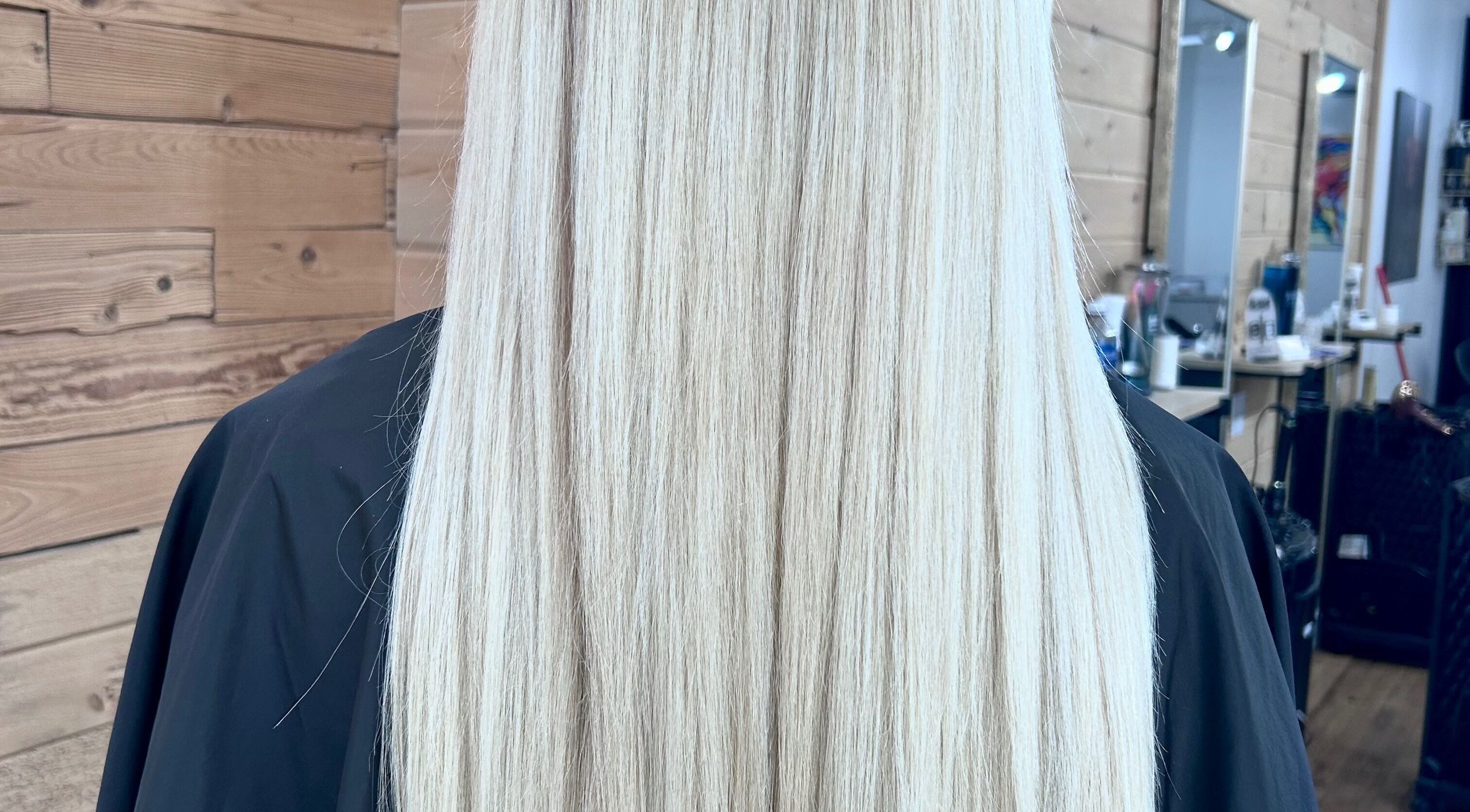 Sleek, long blonde hair styled at Meg's Studio, Orillia, Ontario, CA, showcases expert hair care.