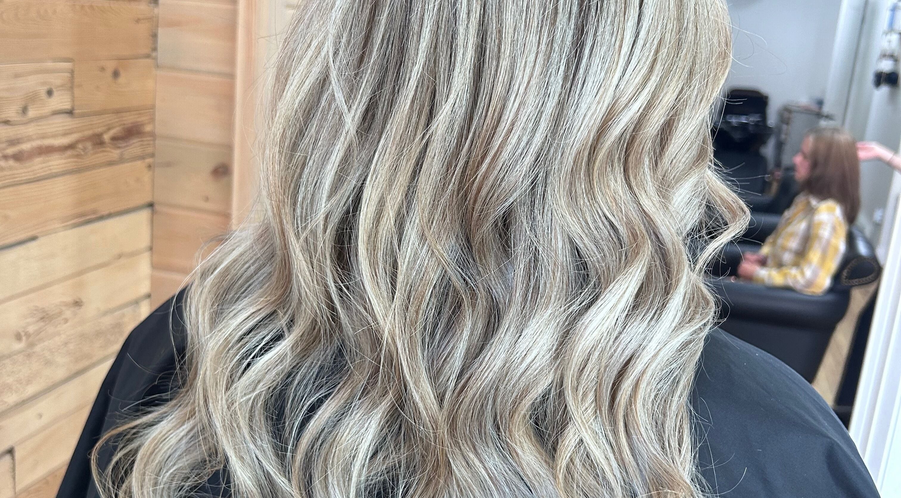 Blonde wavy hairstyle at Meg's Studio, Orillia, Ontario, CA, showcasing natural beauty and hair expertise.