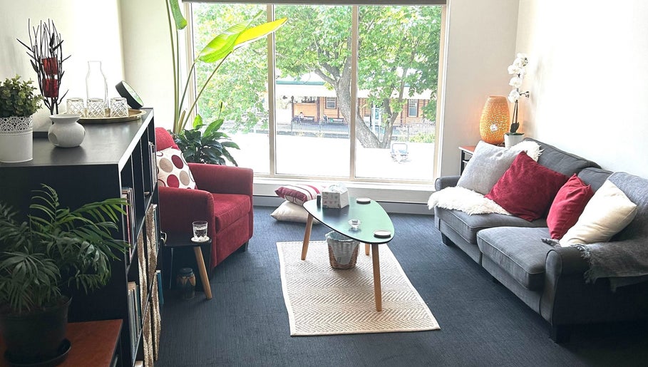 Bright, cozy therapy room at Blue Mountains Therapies, Katoomba, New South Wales, AU with sofa and plants.
