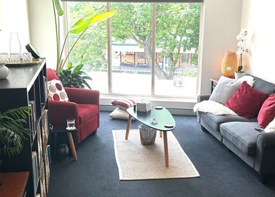 Bright, cozy therapy room at Blue Mountains Therapies, Katoomba, New South Wales, AU with sofa and plants.