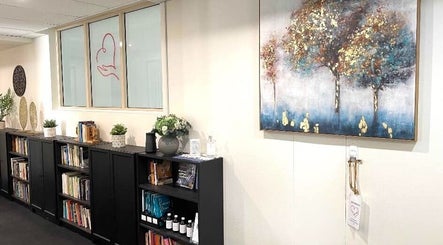 Serene interior of Blue Mountains Therapies in Katoomba, New South Wales, AU with art and book display.