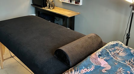 Cozy massage room at Forever Young Beauty, Tongham, England, GB, featuring a plush relaxation bed.