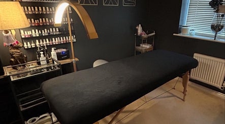 Relaxing treatment room at Forever Young Beauty in Tongham, England, GB with massage bed and calming ambiance.