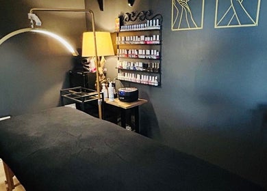 Relaxing treatment room at Forever Young Beauty, Tongham, England, GB with cozy lighting and nail polish display.