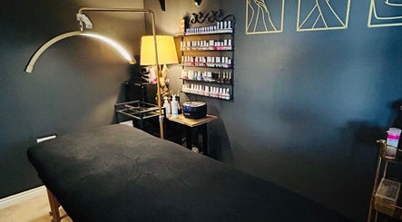 Relaxing treatment room at Forever Young Beauty, Tongham, England, GB with cozy lighting and nail polish display.