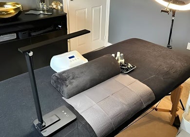 Elegant treatment room at Forever Young Beauty in Tongham, England, GB with plush table and ambient lighting.