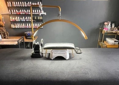 Nail treatment setup at Forever Young Beauty, Tongham, England, GB, featuring polish display and modern equipment.