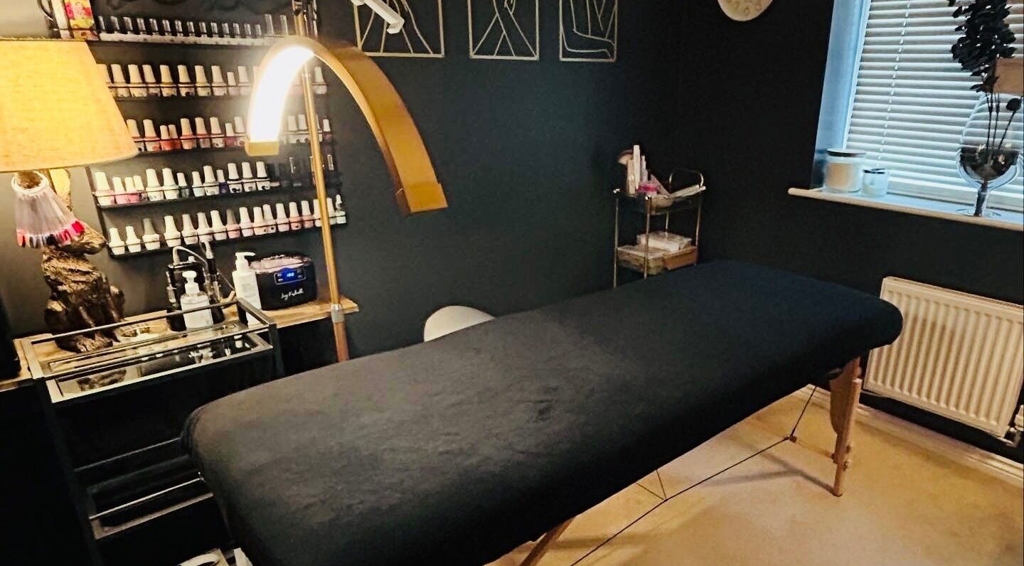 Relaxing treatment room at Forever Young Beauty, Tongham, England, GB with a cozy massage bed and products.