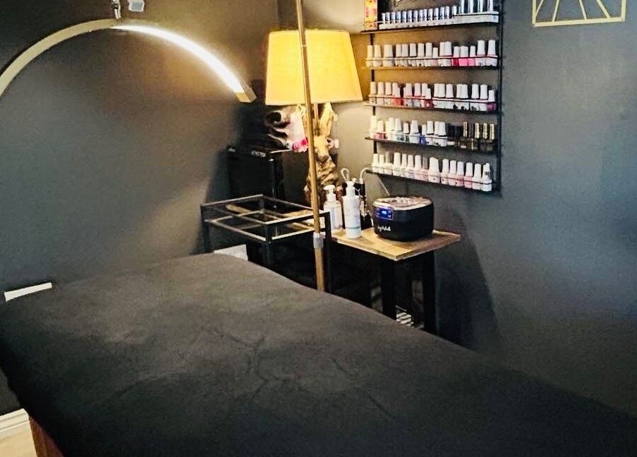 Relaxing treatment room at Forever Young Beauty in Tongham, England, GB featuring a massage table and nail polish.