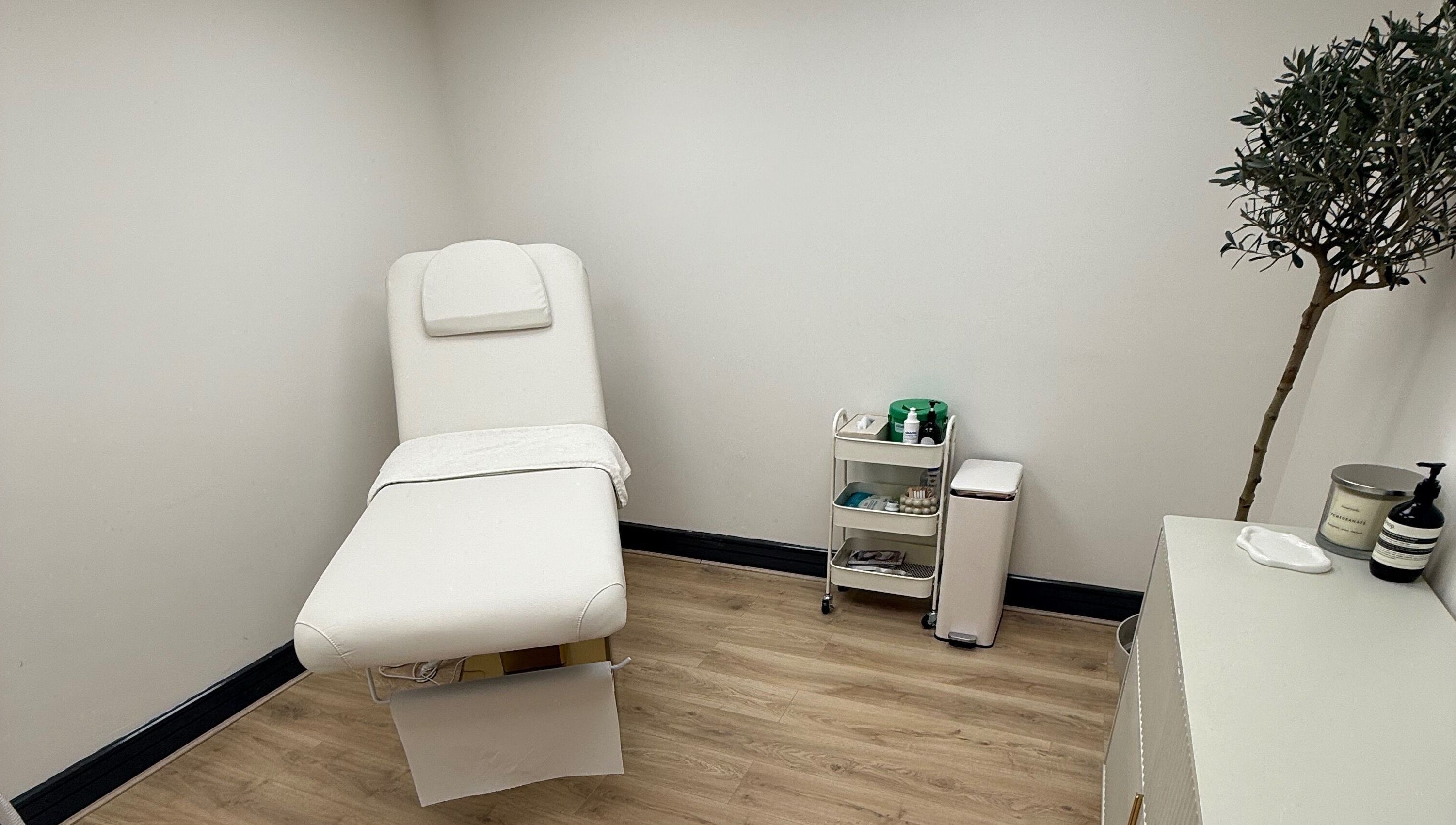 Elegant treatment room at Laser by Lucy, Southend-on-sea, England, GB with a plush white therapy bed.