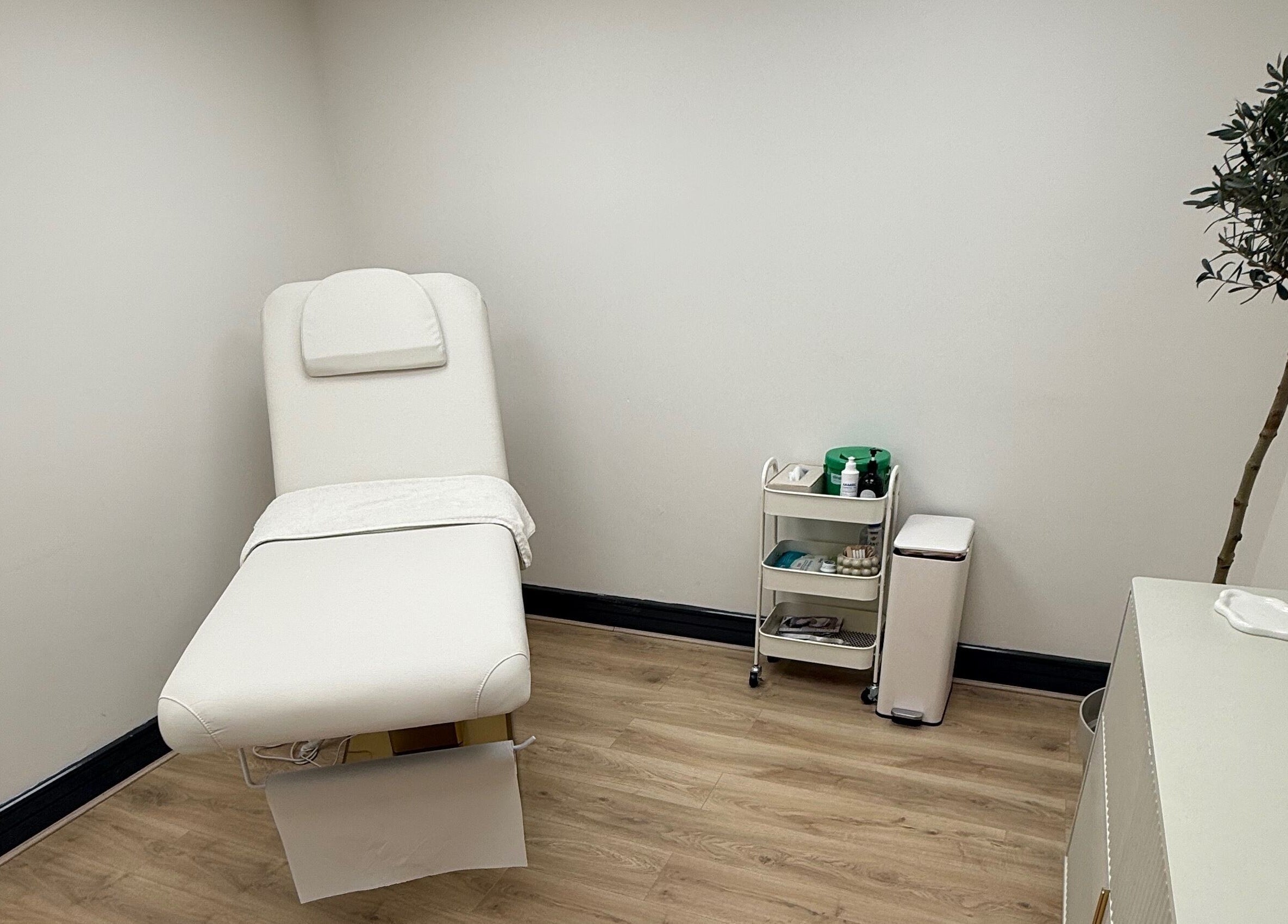 Elegant treatment room at Laser by Lucy, Southend-on-sea, England, GB with a plush white therapy bed.