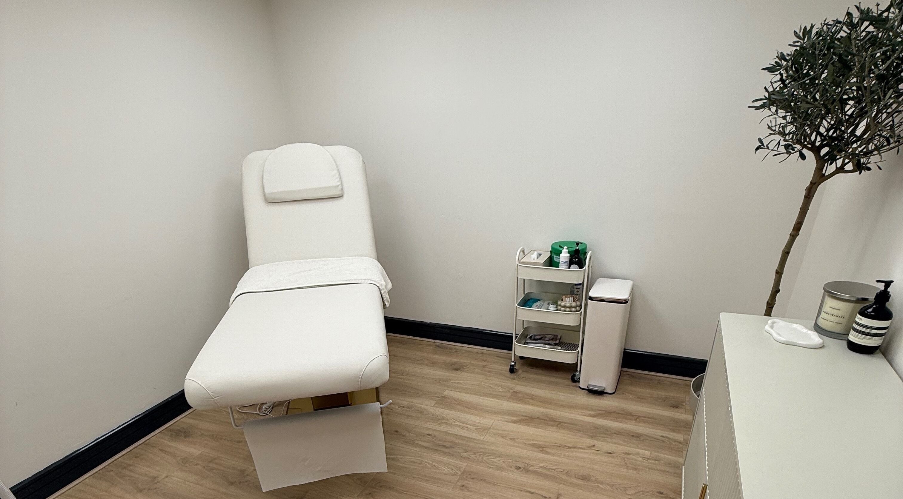 Elegant treatment room at Laser by Lucy, Southend-on-sea, England, GB with a plush white therapy bed.