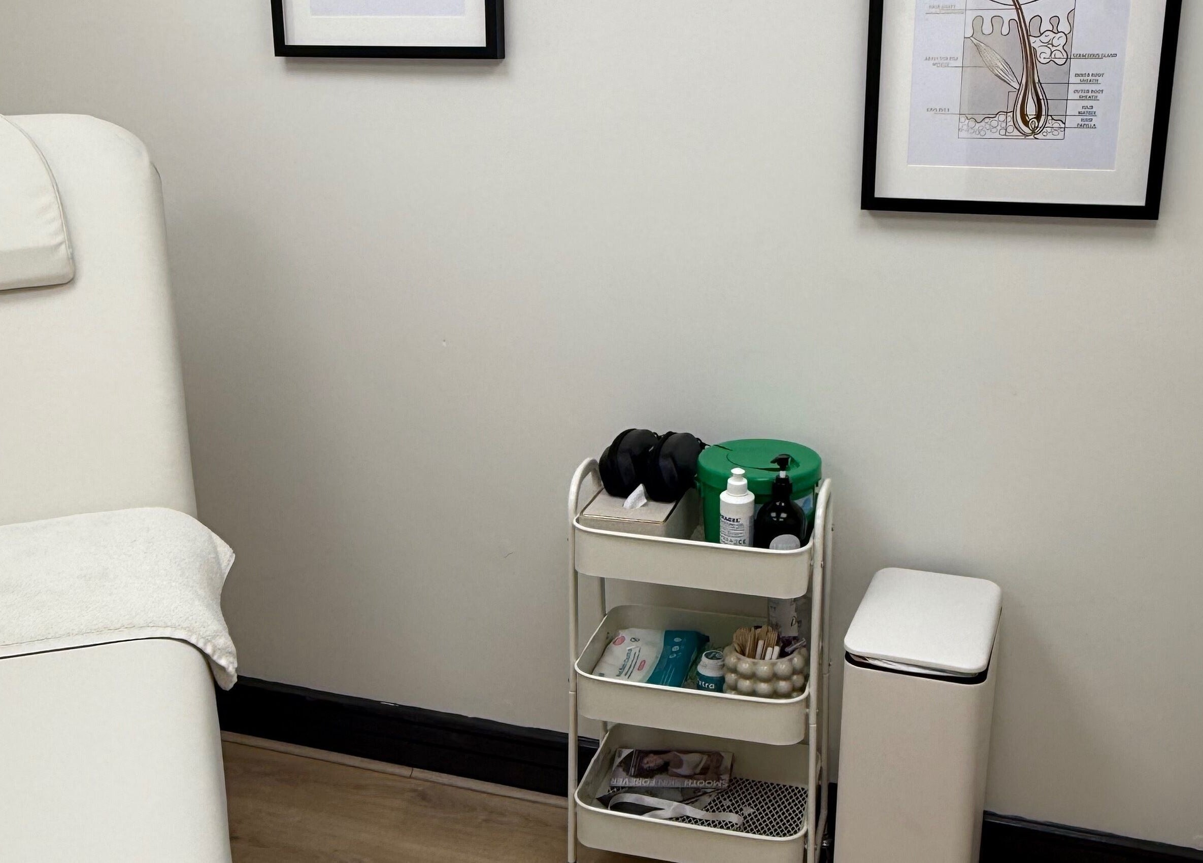 Clean, minimalist treatment room at Laser by Lucy, Southend-on-sea, England, GB featuring a cozy bed and essential tools.