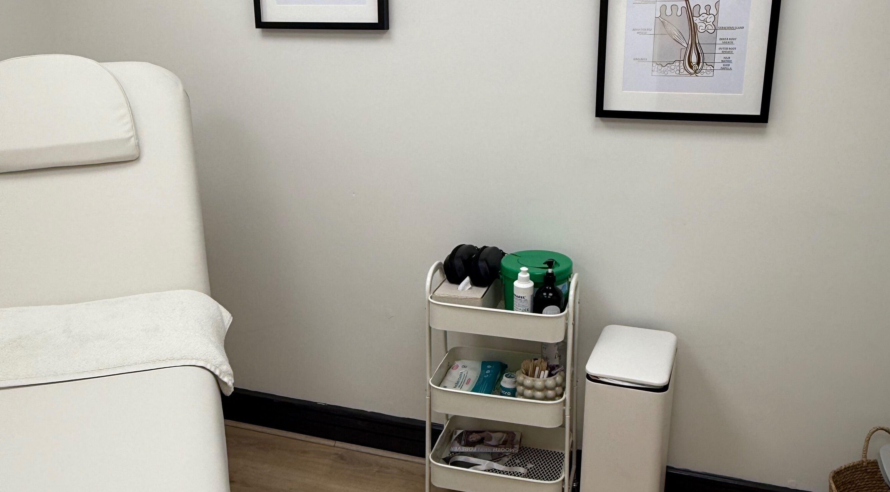 Clean, minimalist treatment room at Laser by Lucy, Southend-on-sea, England, GB featuring a cozy bed and essential tools.