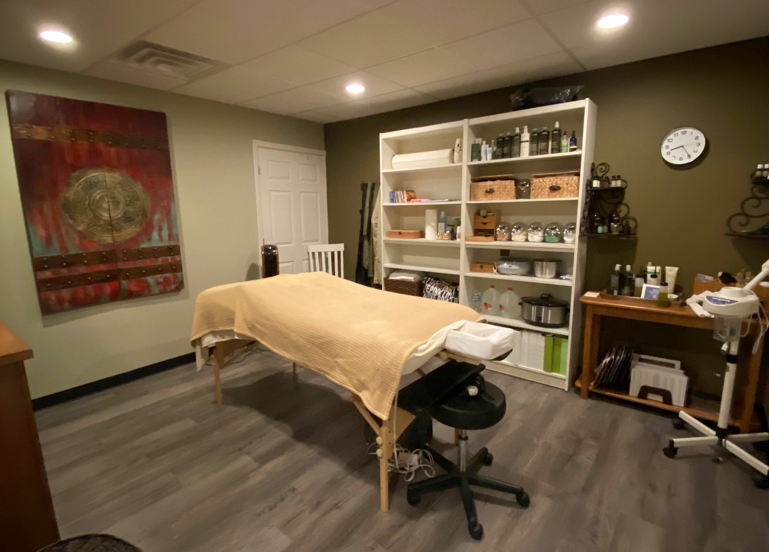 Relaxing treatment room at Studio 101 Salon and Spa, Swanton, Ohio, US, with massage table and wellness decor.