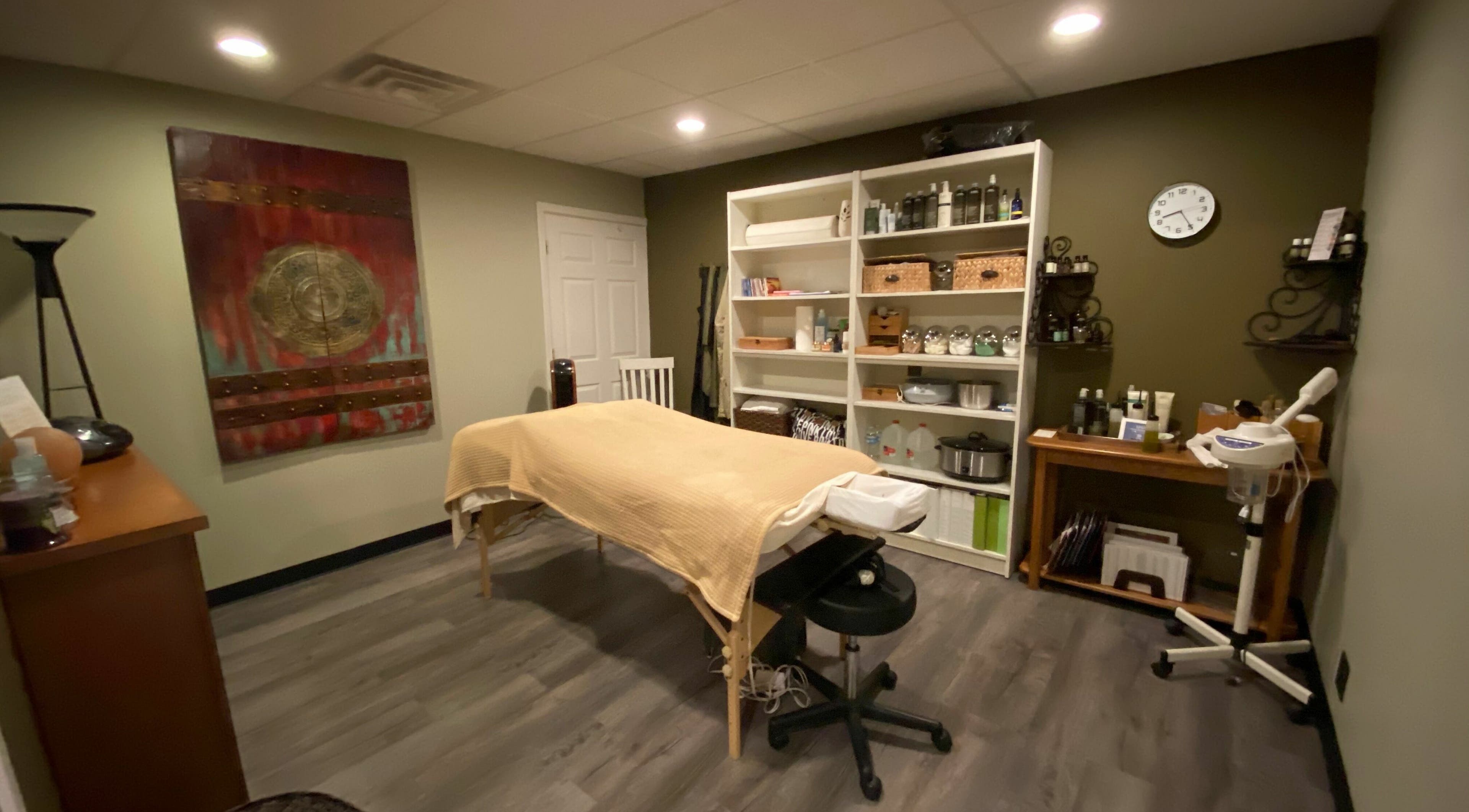 Relaxing treatment room at Studio 101 Salon and Spa, Swanton, Ohio, US, with massage table and wellness decor.