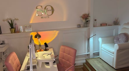 Stylish interior of Sarah Ollivierre Beauty in London, England, GB, featuring pink chairs and elegant decor.