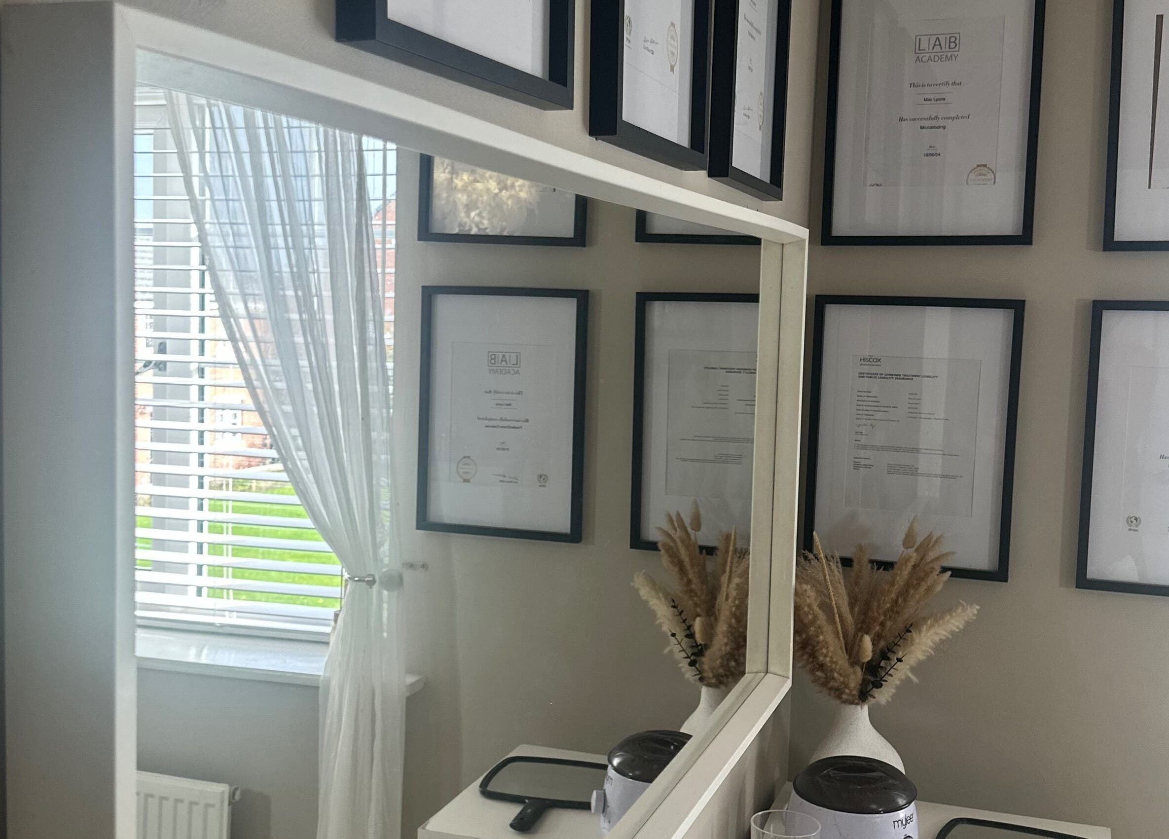 Elegant framed certificates at Haus Of Lyons, Spennymoor, enhancing the tranquil spa ambiance.