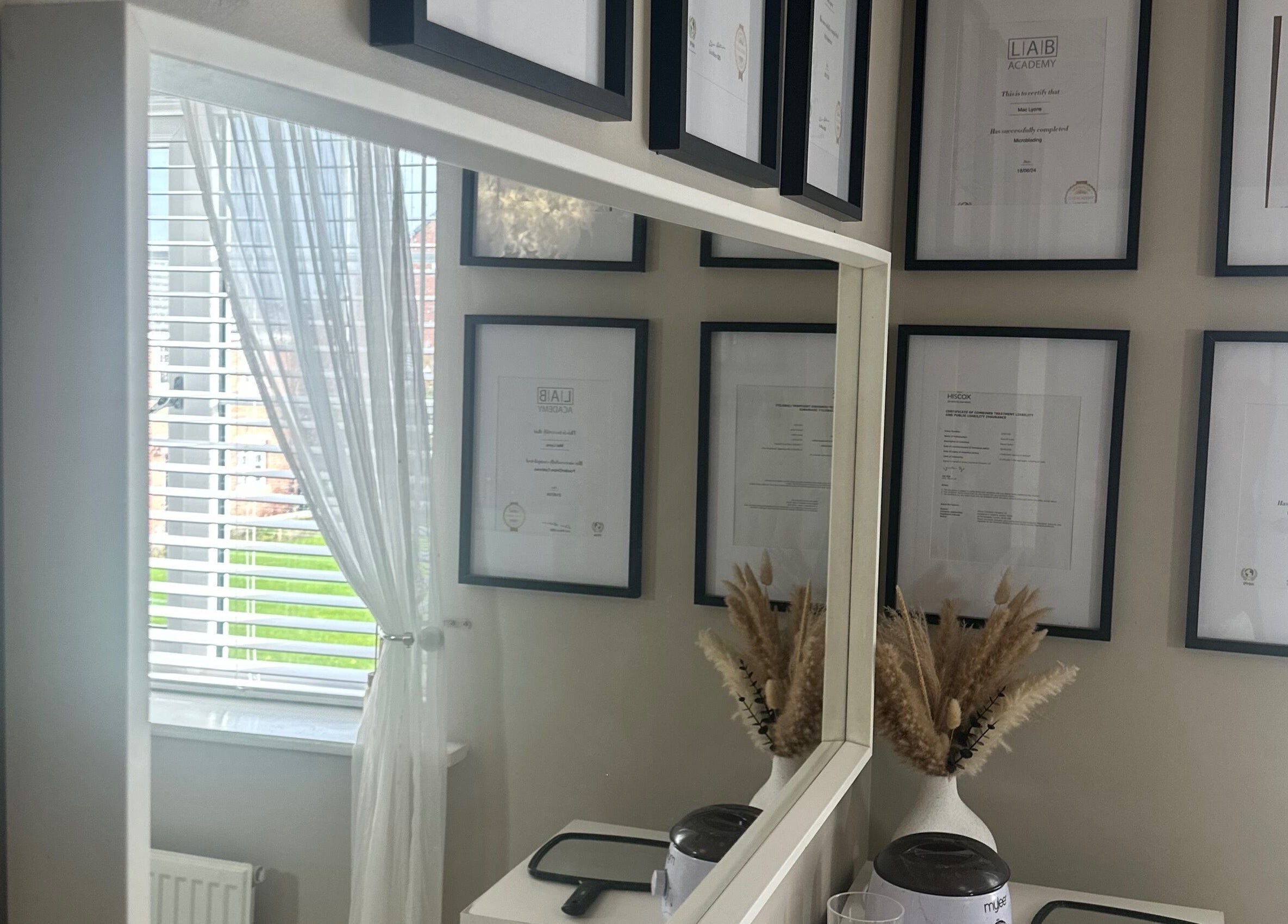 Elegant framed certificates at Haus Of Lyons, Spennymoor, enhancing the tranquil spa ambiance.