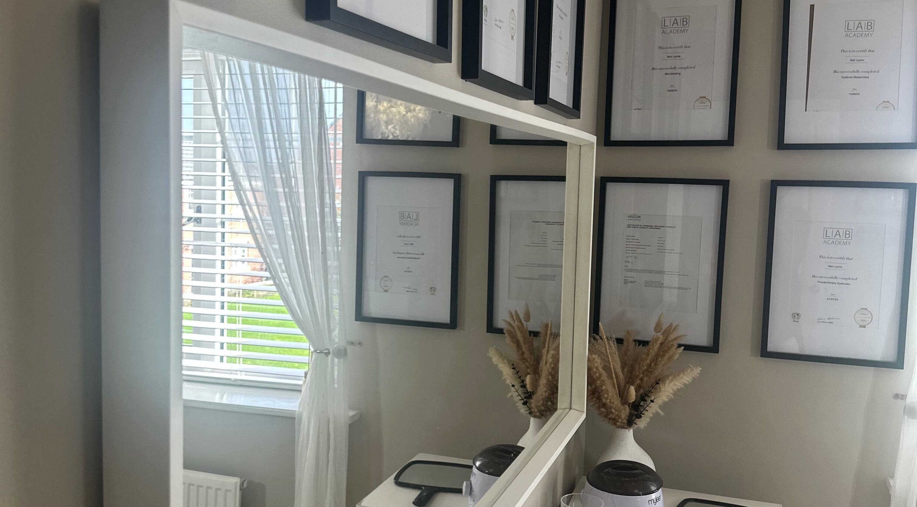 Elegant framed certificates at Haus Of Lyons, Spennymoor, enhancing the tranquil spa ambiance.